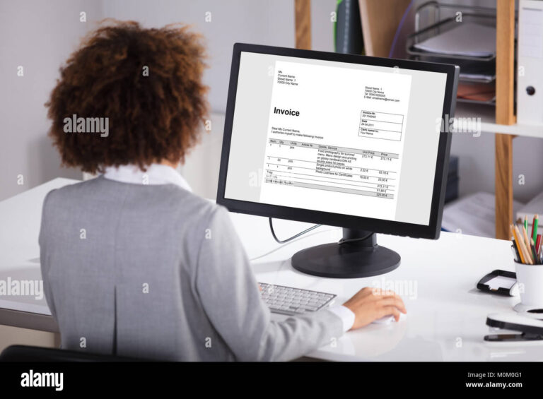 persona trabajando en computadora con factura